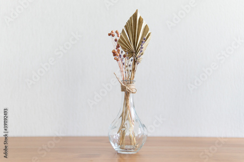 autumn wedding stationery still life. Empty wall mockup scene on background of dry palm leaf in vase. Grunge white textured background. Horizontal layout, side view. Tropical vacation concept. Boho 