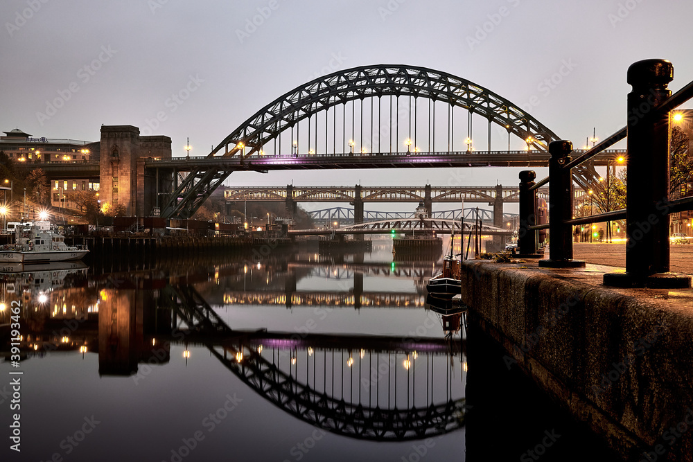 Fototapeta premium Tyne Bridge on River Tyne - Newcastle Upon Tyne - Night City shot with lights and reflection