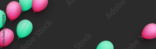 Pink and green balloons with threads on black background.