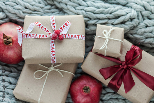Fototapeta Naklejka Na Ścianę i Meble -  Christmas presents and boxes on gray knitted cozy background 