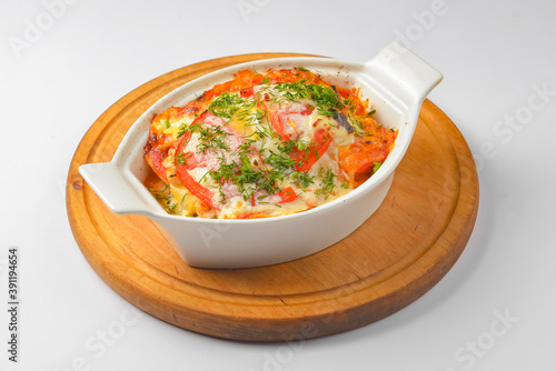 Italian lasagna served in a white pot over white background. Delicioud dinner concept, Italian cuisine.