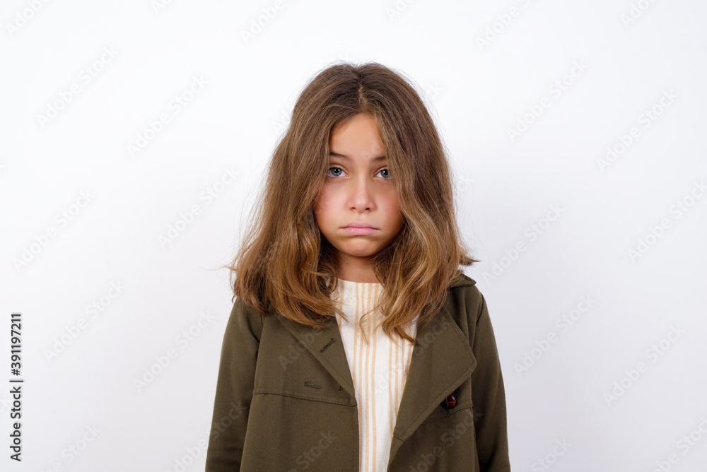Beautiful little girl standing against white background, crying desperate and depressed with tears on his eyes suffering pain and depression. Sad facial expression and emotion concept. Beautiful little girl standing against white background, crying desperate and depressed with tears on his eyes suffering pain and depression. Sad facial expression and emotion concept.