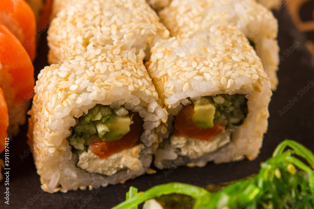 Japanese food: Set of salmon sushi and rolls with salmon and eel Japanese food: Set of salmon sushi and rolls with salmon and eel