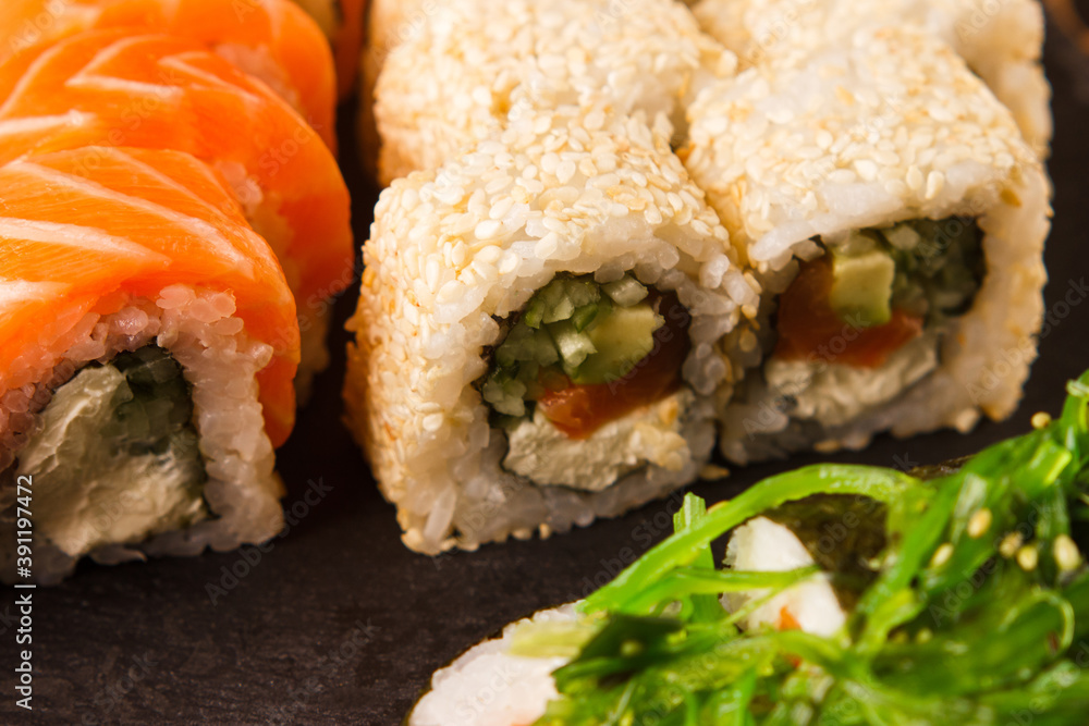 Japanese food: Set of salmon sushi and rolls with salmon and eel Japanese food: Set of salmon sushi and rolls with salmon and eel