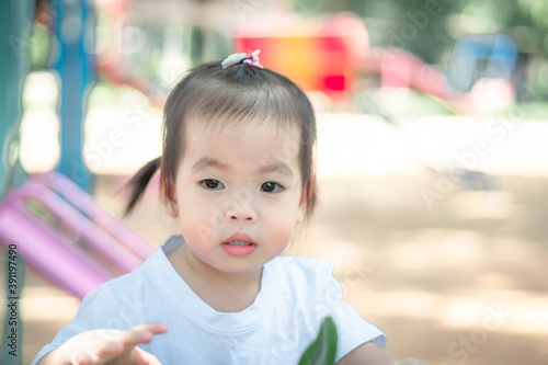 Beautiful cute asian little girl in the morning on the meadow