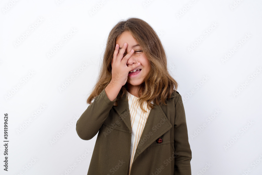 Charismatic carefree joyful Beautiful little girl standing against white background, likes laugh out loud not hiding emotions giggling hear funny hilarious joke chuckling facepalm. Charismatic carefree joyful Beautiful little girl standing against white background, likes laugh out loud not hiding emotions giggling hear funny hilarious joke chuckling facepalm.