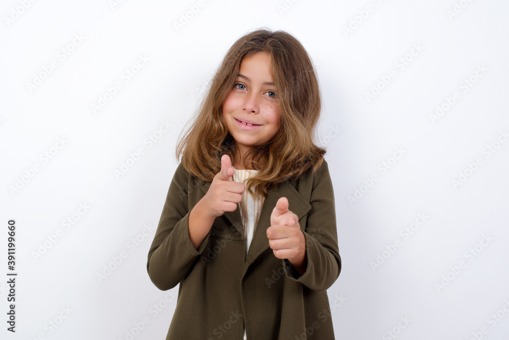 Beautiful little girl standing against white background, pointing at camera with index fingers on both hands with happy expression, Good job, I choose you. Copy space. Beautiful little girl standing against white background, pointing at camera with index fingers on both hands with happy expression, Good job, I choose you. Copy space.