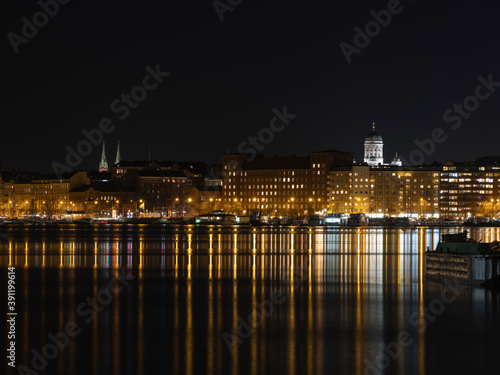 Illuminated Helsinki waterfront with Helsinki Cathedral in the background.