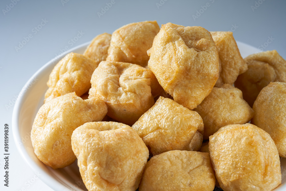 Close-up of a bowl of golden tempting fried tofu with avocado oil Close-up of a bowl of golden tempting fried tofu with avocado oil