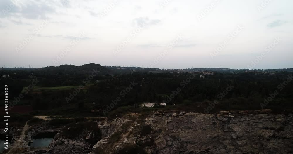 Aerial dolly forward over rock formation at twilight Aerial dolly forward over rock formation at twilight
