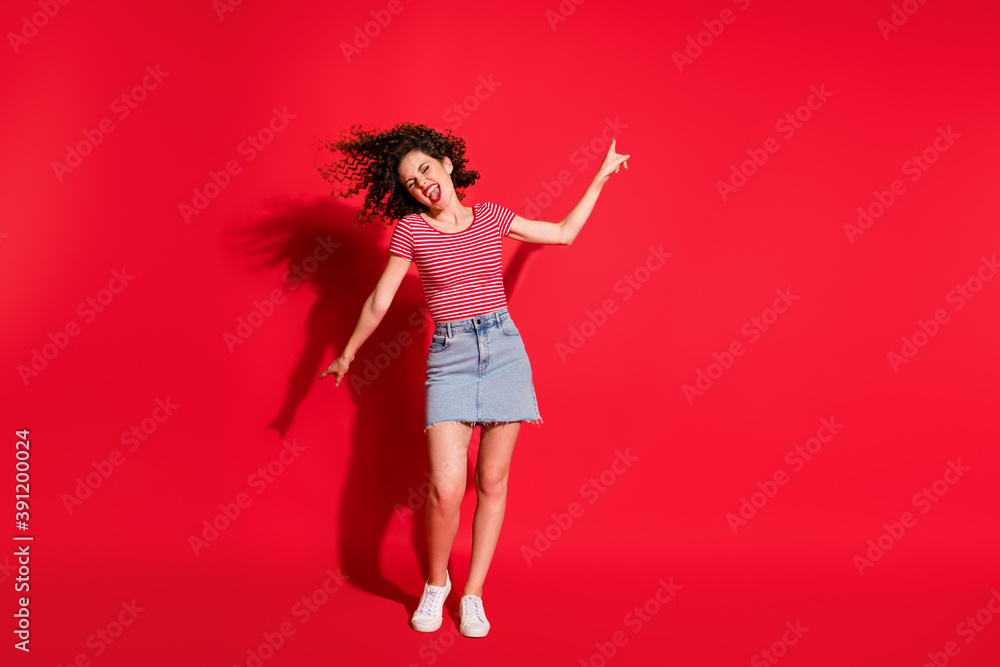Full body photo of crazy active girl have fun enjoy point fingers empty space yell isolated over red color background Full body photo of crazy active girl have fun enjoy point fingers empty space yell isolated over red color background
