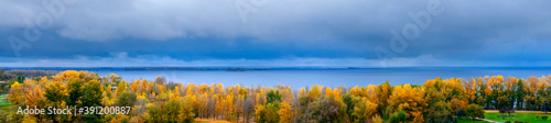 Autumn landscape. Golden autumn. View of the forest and the river. Panoramic view.