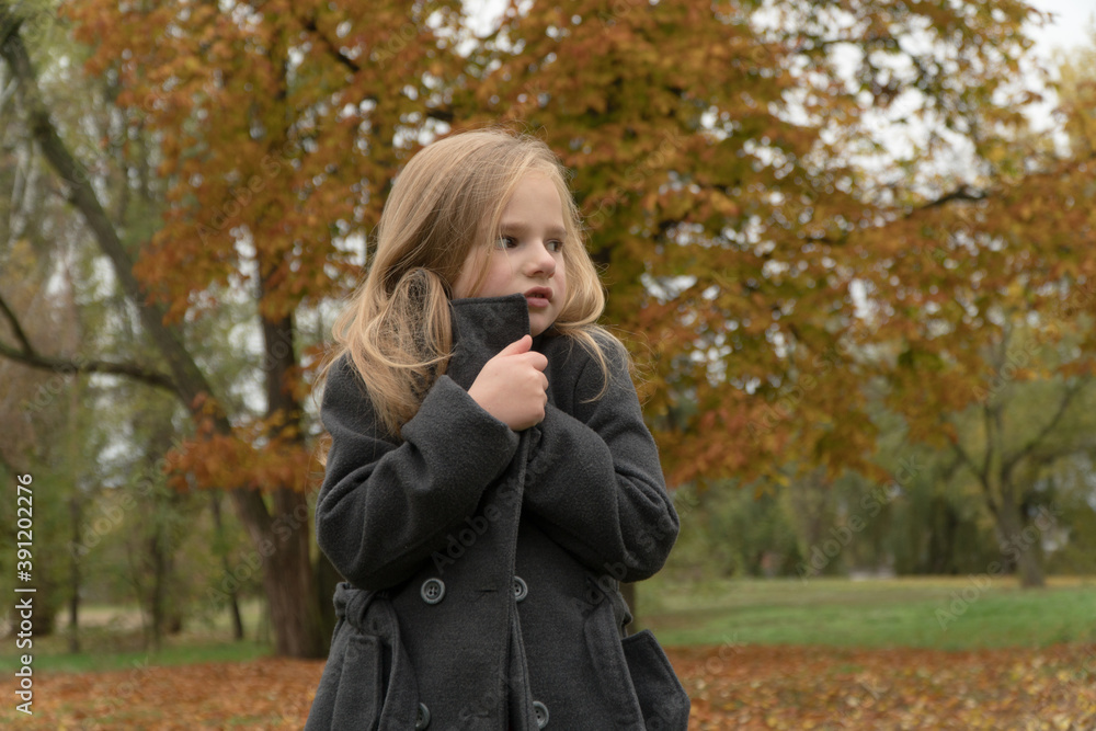 child froze walking in the autumn park
child froze walking in the autumn park