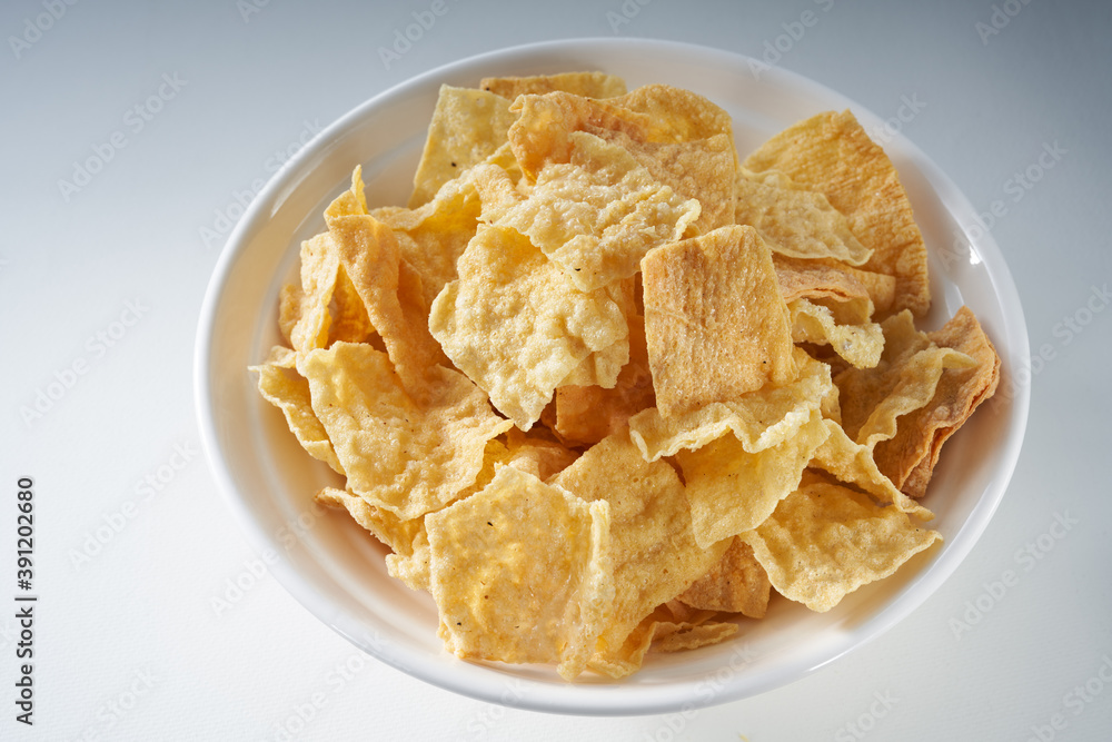 Closeup of a bowl of golden tempting fried yuba