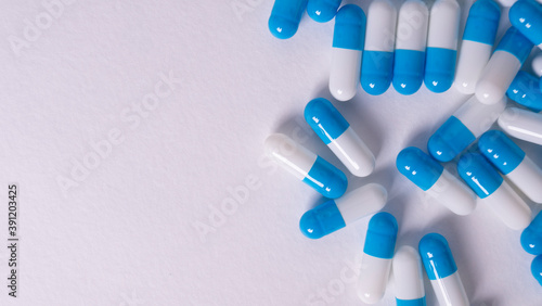 white and blue pills on white background