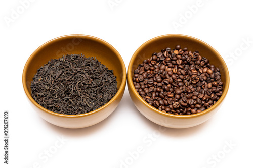 Bowls with coffee and dried tea on a white background