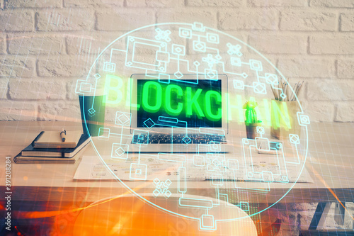 Double exposure of blockchain theme hologram and table with computer background. Concept of bitcoin crypto currency. photo