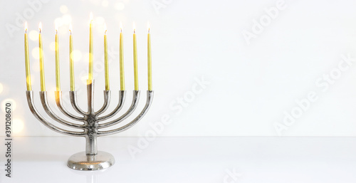Religion image of jewish holiday Hanukkah background with menorah (traditional candelabra) and candles © tomertu