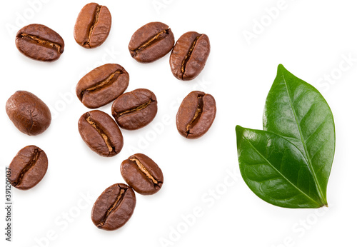 roasted coffee beans with green leaves isolated on white background. Clipping path and full depth of field. Top view