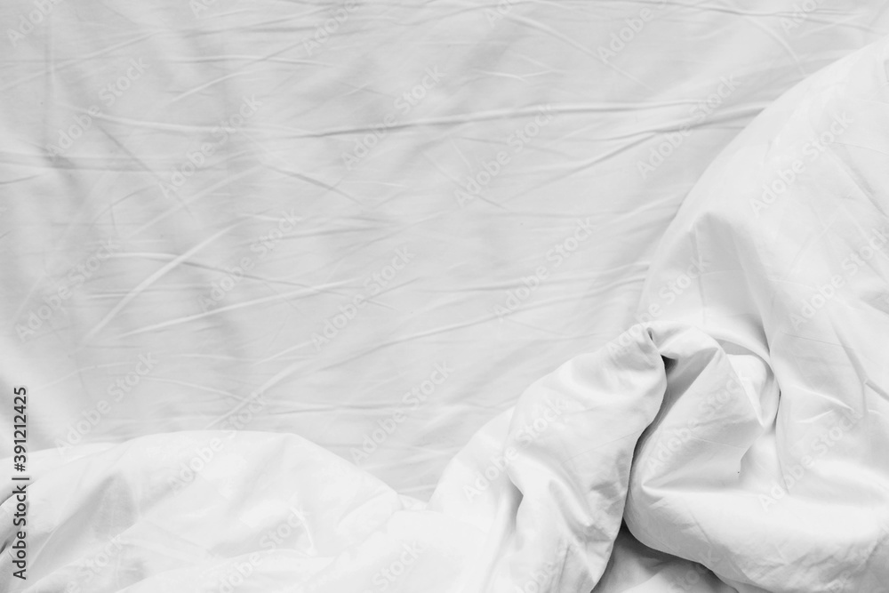 Top view of white cotton crumpled sheet and crumpled blanket with copy space. Flat lay, top view Top view of white cotton crumpled sheet and crumpled blanket with copy space. Flat lay, top view