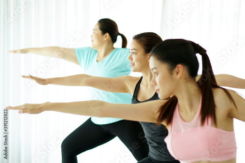 Group of 3 women practicing yoga together