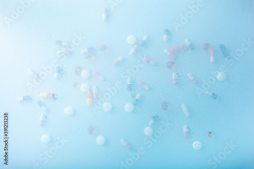 pill tablet capsule medicine through water drops background