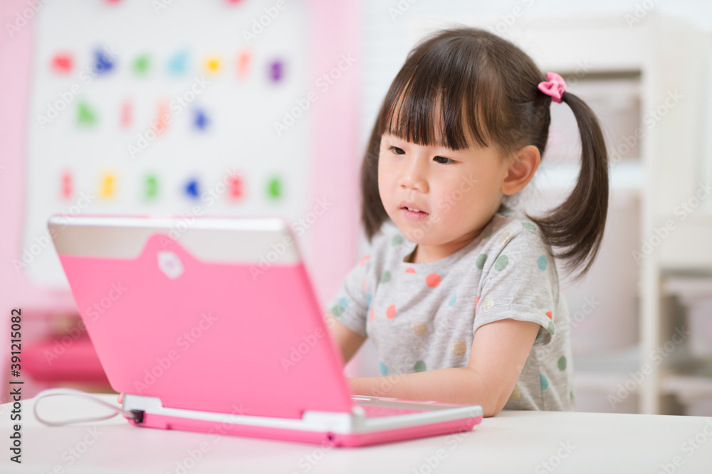 young girl using laptop for online learning during lockdown time young girl using laptop for online learning during lockdown time