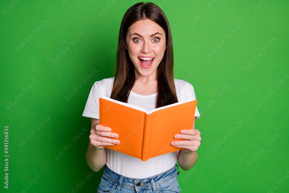 Photo of surprised pretty cheerful brunette girl read book wear white t-shirt isolated on green color background Photo of surprised pretty cheerful brunette girl read book wear white t-shirt isolated on green color background