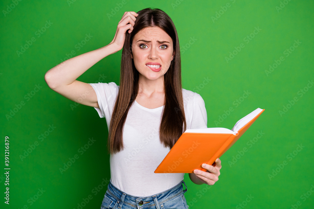 Portrait of pretty confused intellectual girl nerd reading book wear casual t-shirt isolated on green background Portrait of pretty confused intellectual girl nerd reading book wear casual t-shirt isolated on green background