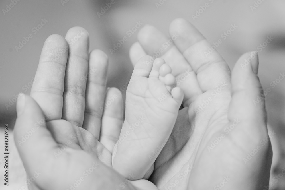 Detail of a newborn toe between her mother's hands Detail of a newborn toe between her mother's hands