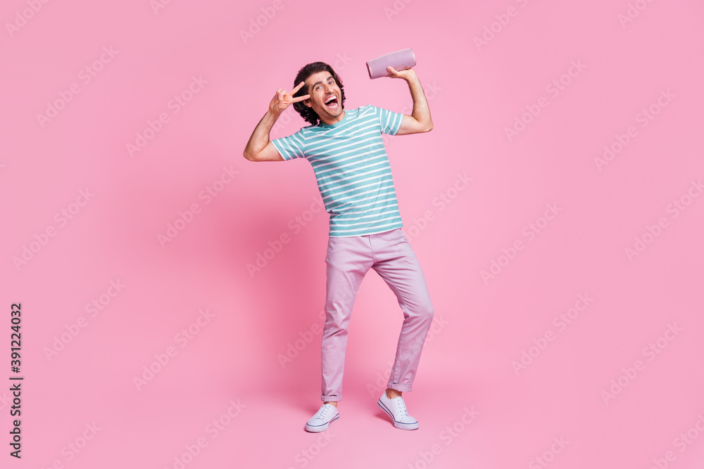Full length photo of dancing young gentleman wear casual outfit holding modern device showing v-sign isolated pastel color background