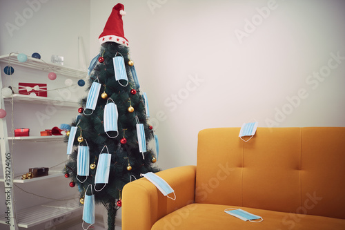 Christmas tree decorated with surgical masks - illustration to virus pandemic 2020 / 2021 social distance, lockdown and quarantine isolation. photo