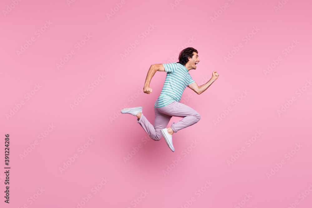 Full length photo of purposeful young gentleman wear casual outfit jumping running isolated pastel color background