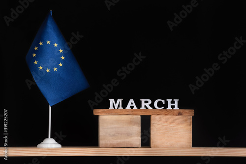 Wooden calendar of March with flag EU on black background. Holidays of European Union in March