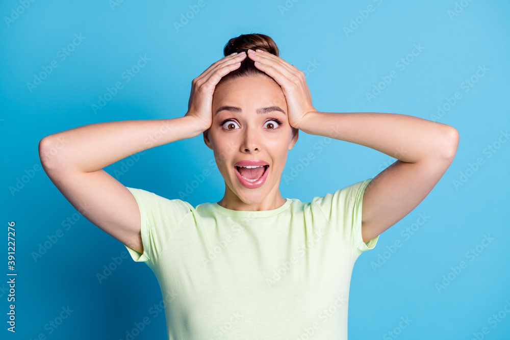 Photo of astonished girl touch hands head shout isolated over blue pastel color background Photo of astonished girl touch hands head shout isolated over blue pastel color background