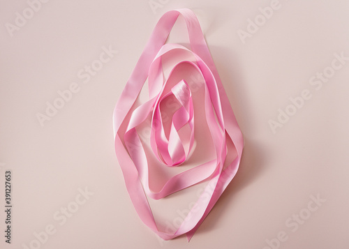 Creative art photography made of pink ribbon. Vagina concept, female energy photo