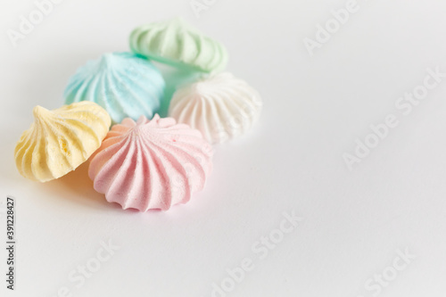 Pastel colored meringue on white background
