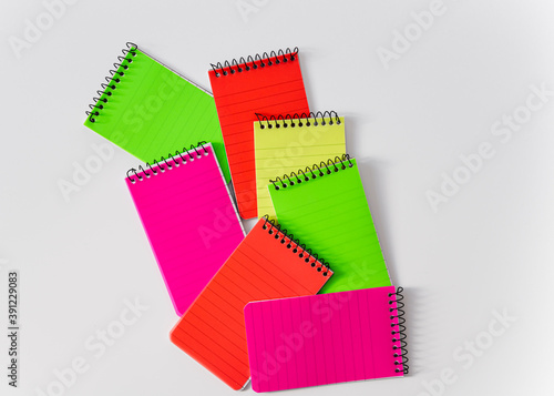 Colourful notebooks on white background