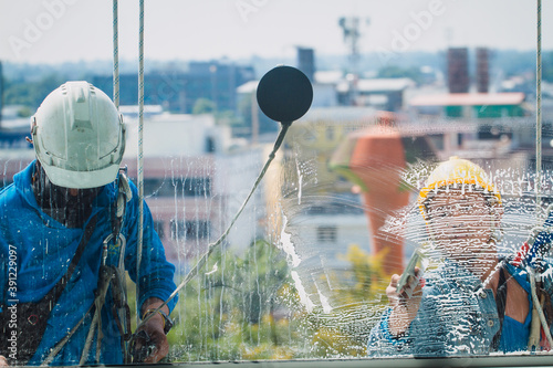 The spider man team cleaning glass and window before hand over at  construction site.