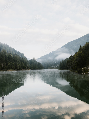 Foggy early morning on the mountain lake © marjan4782