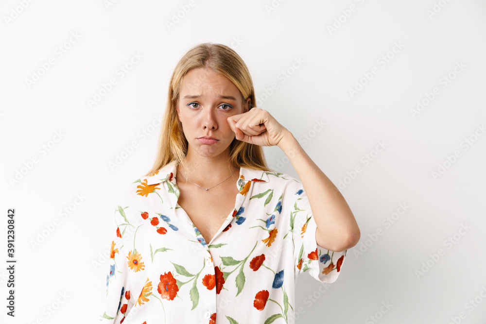 Unhappy beautiful girl crying while posing at camera Unhappy beautiful girl crying while posing at camera