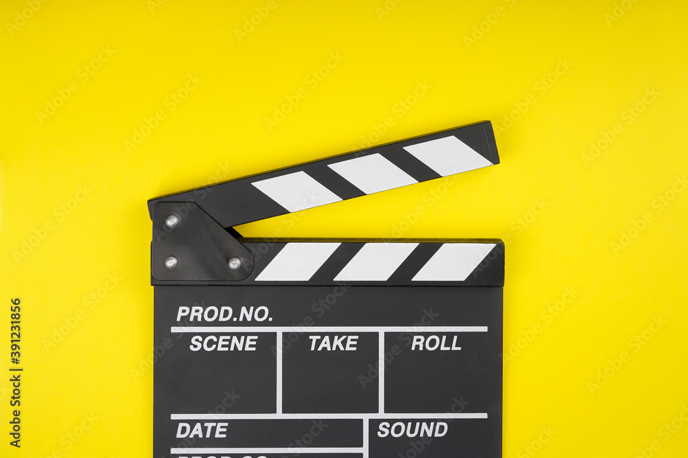 Clapperboard on yellow background. Movie, filmmaking, cinema concept. Top view, flat lay, copy space