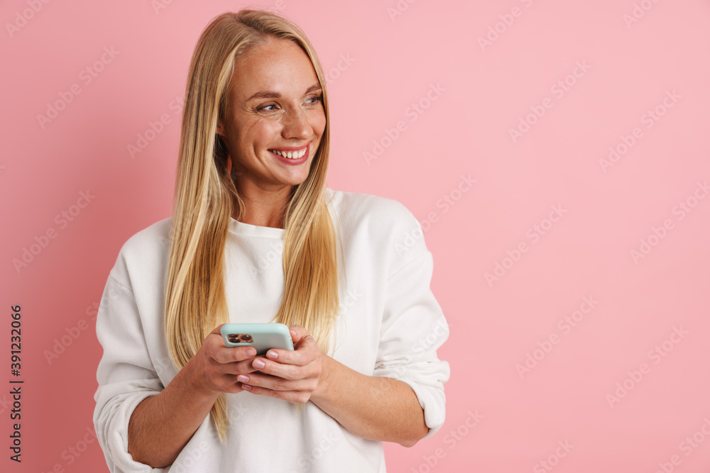 Joyful beautiful girl smiling and using cellphone Joyful beautiful girl smiling and using cellphone