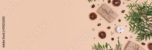 Banner with natural Christmas gifts and decorations on a beige background. Zero waste concept with place for text.