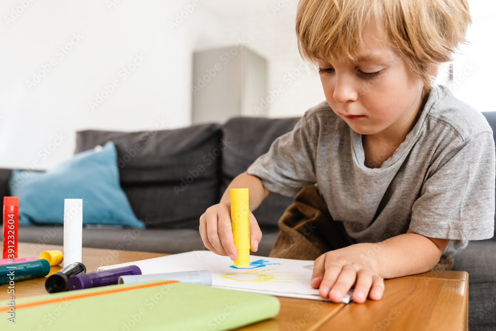 Concentrated little boy drawing at home Concentrated little boy drawing at home