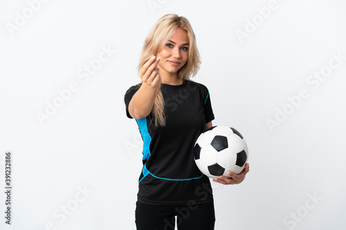 Young Russian woman playing football isolated on white background making money gesture
