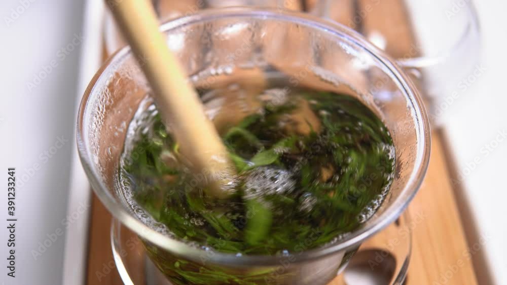 Cooking brewing green Chinese tea close up in a glass Cup Cooking brewing green Chinese tea close up in a glass Cup
