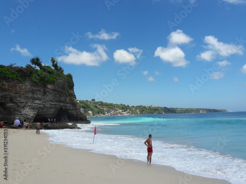 фотографія A person on the beach at Dreamland, Uluwatu, Bali, Indonesia
