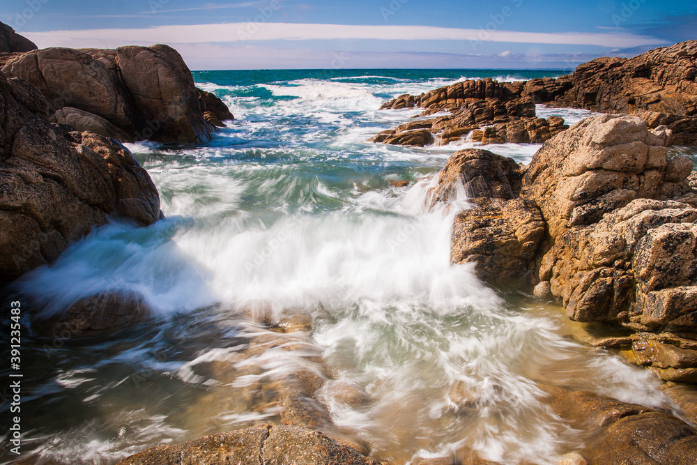 waves crashing on rocks, sunny day by ocean with blue sky and nice cliffs, france, brittany waves crashing on rocks, sunny day by ocean with blue sky and nice cliffs, france, brittany