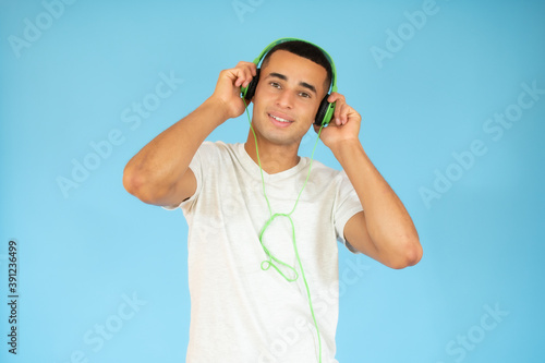 Happy young man with headphones. Listening music